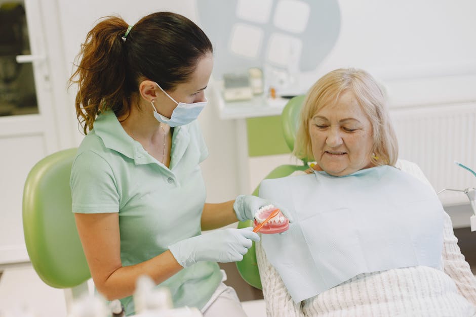 pexels-photo-5622025-5622025 A dentist demonstrating dental health techniques to an elderly patient in a clinic.